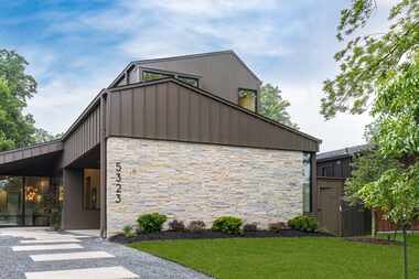 Contemporary home exterior with medal siding and stone