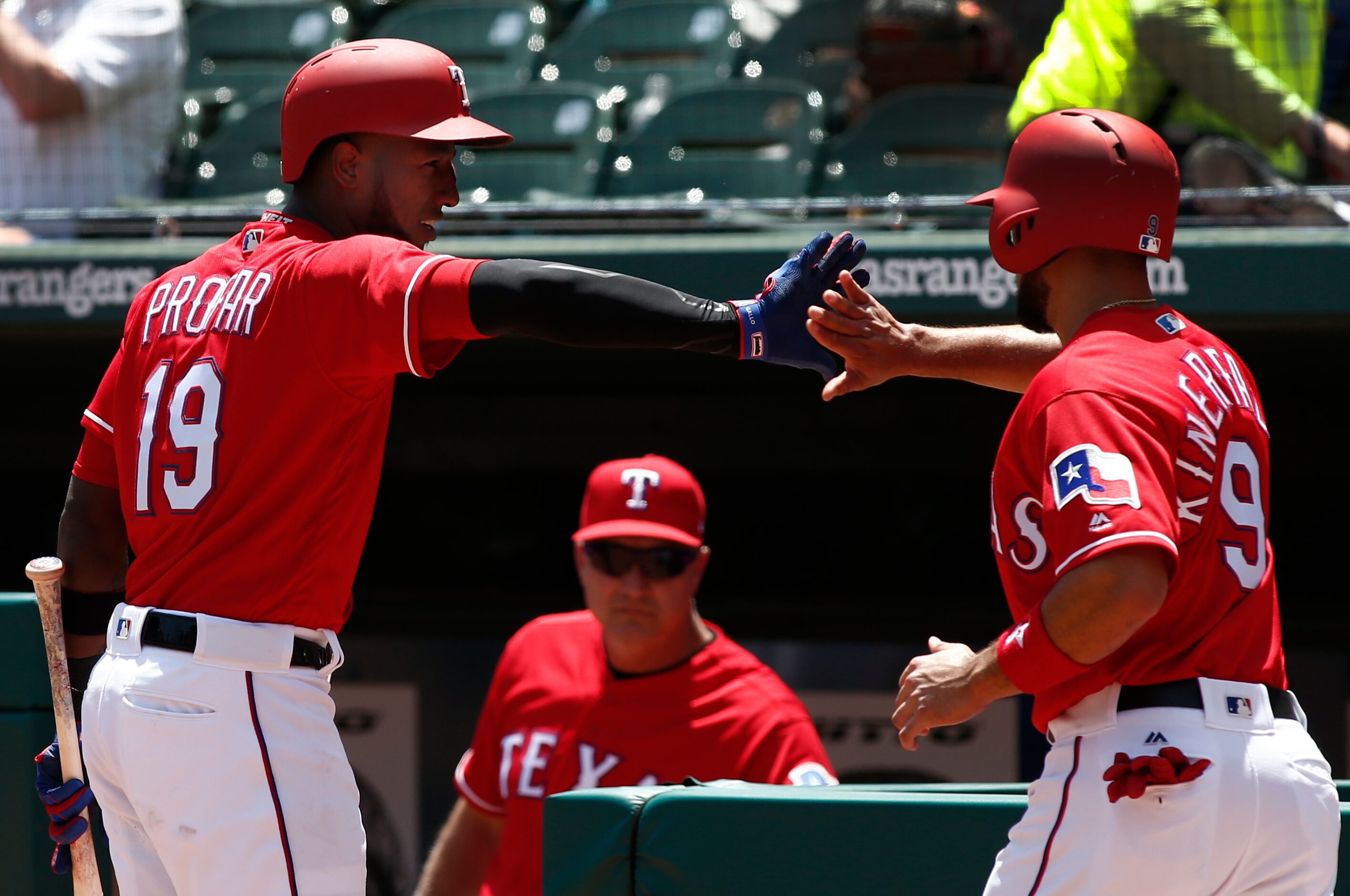 Texas Rangers' Isiah Kiner-Falefa (9) is congratulated by Jurickson Profar (19) after he...