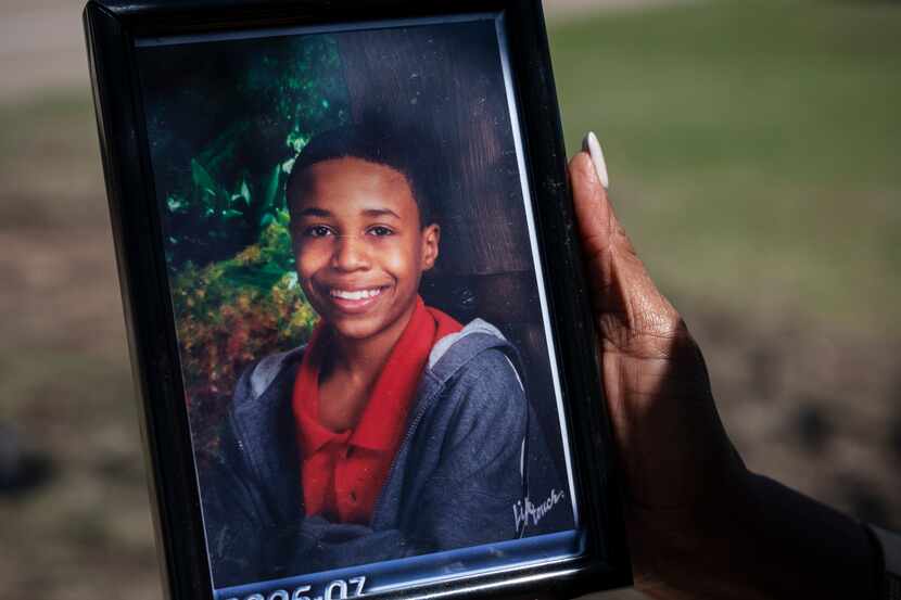 Donna Fields holds a photo of her son Marcus Bell Jr. Bell says that when he was 13, he was...