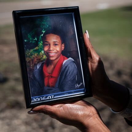 Donna Fields, 47, holds a photo of her son Marcus Bell Jr., who says Rush raped him when he...