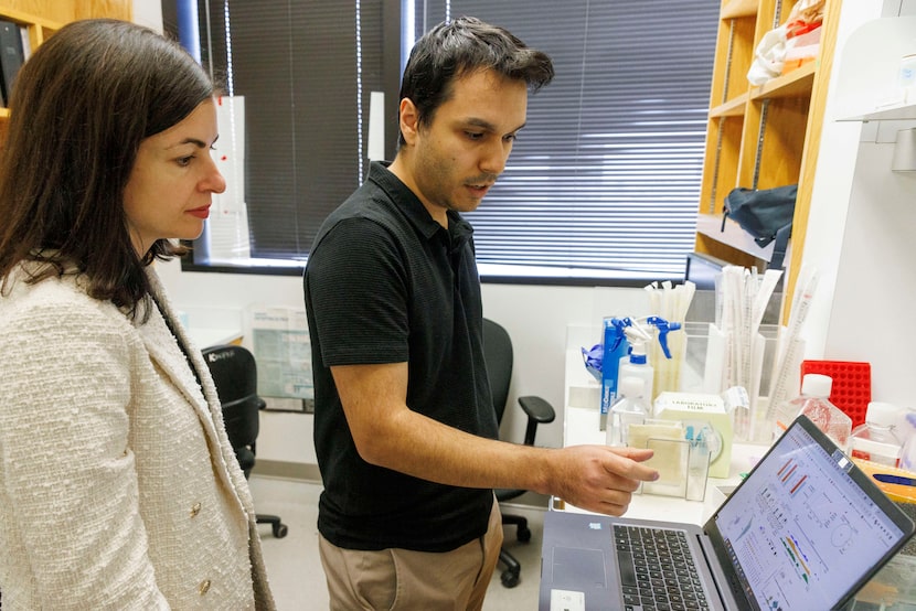 Lead scientist Genevieve Konopka watches as graduate student Emre Caglayan talks through...