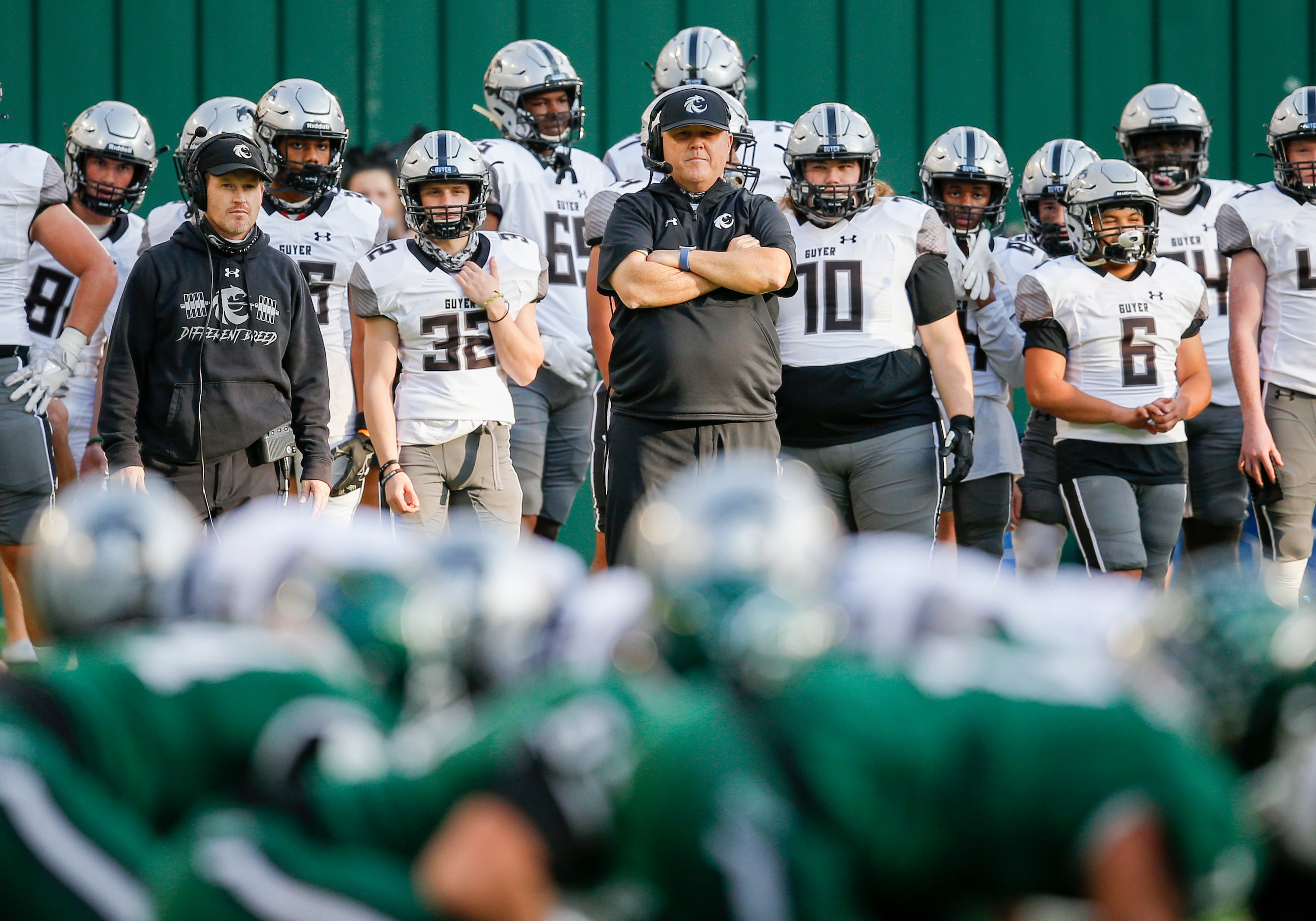 Denton Guyer head coach Rodney Webb, center, looks on during the first half of a high school...