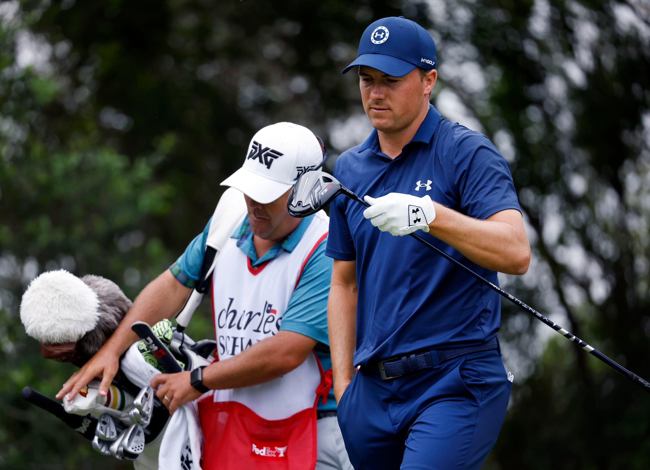 Professional golfer Jordan Spieth looks at his club face after hitting his drive off the No....