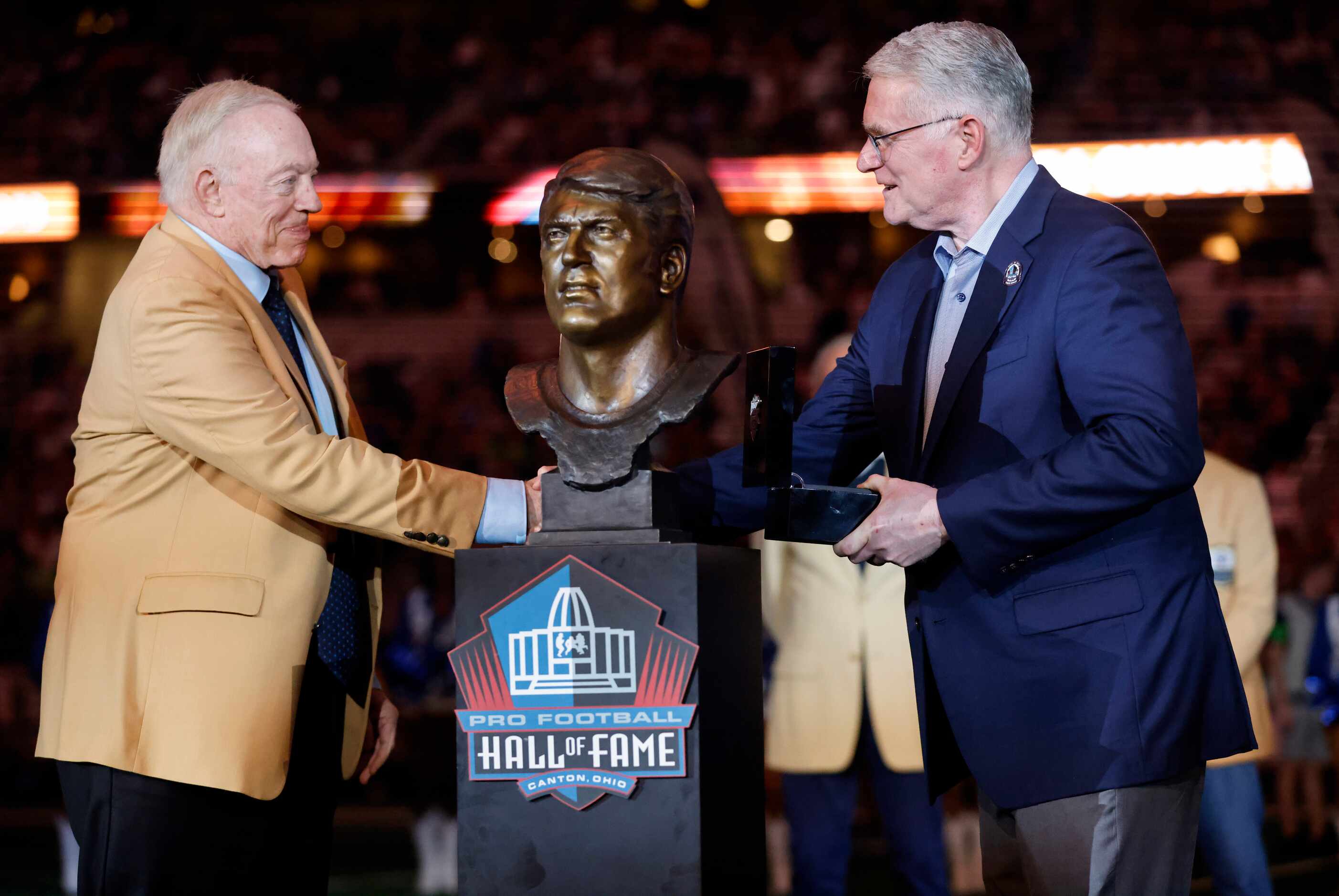 Dallas Cowboys owner Jerry Jones (left) presents Scott Howley, son of Pro Football Hall of...