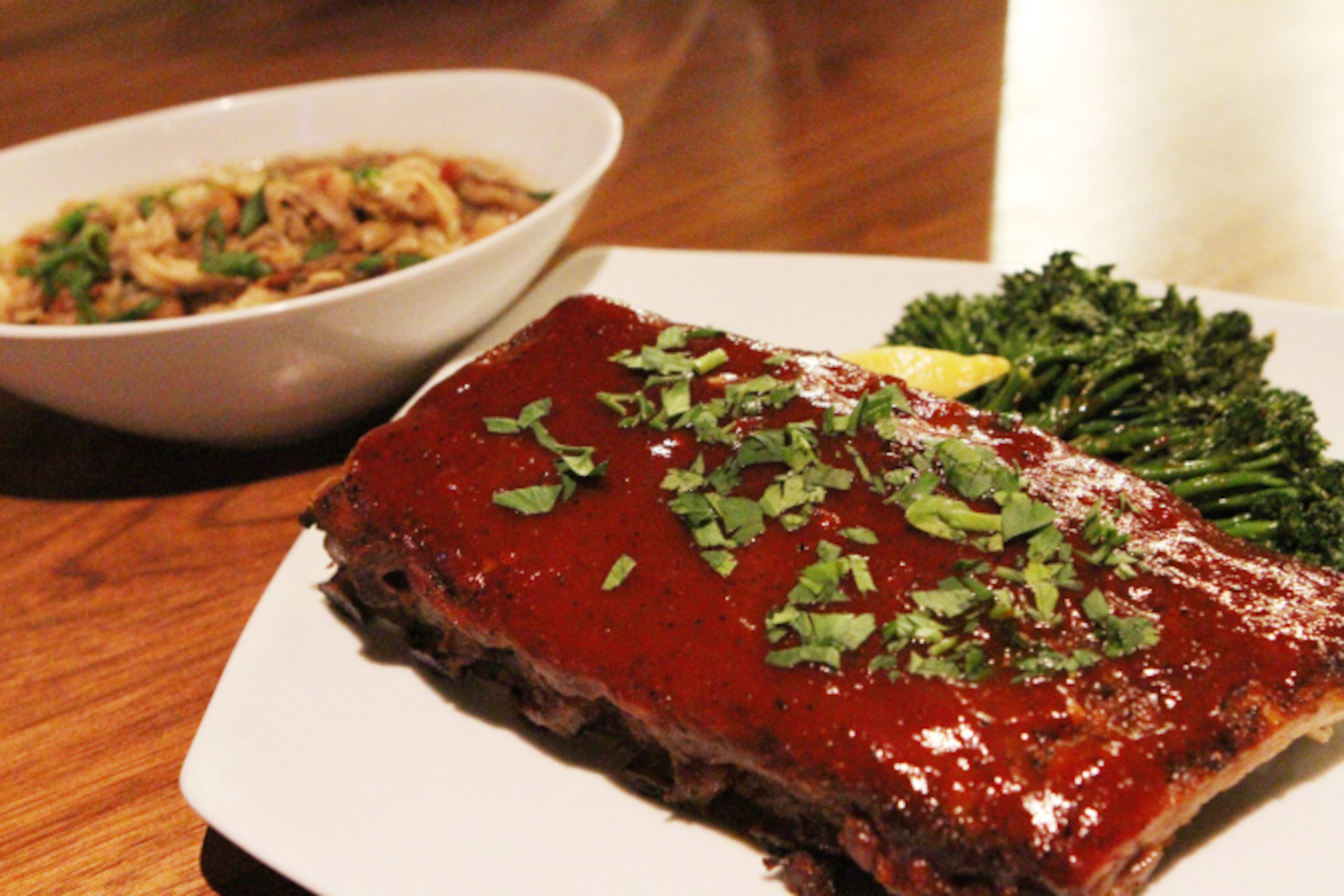 Park Tavern's saucy baby back ribs, shown here with pork and beans and sauteed broccolini