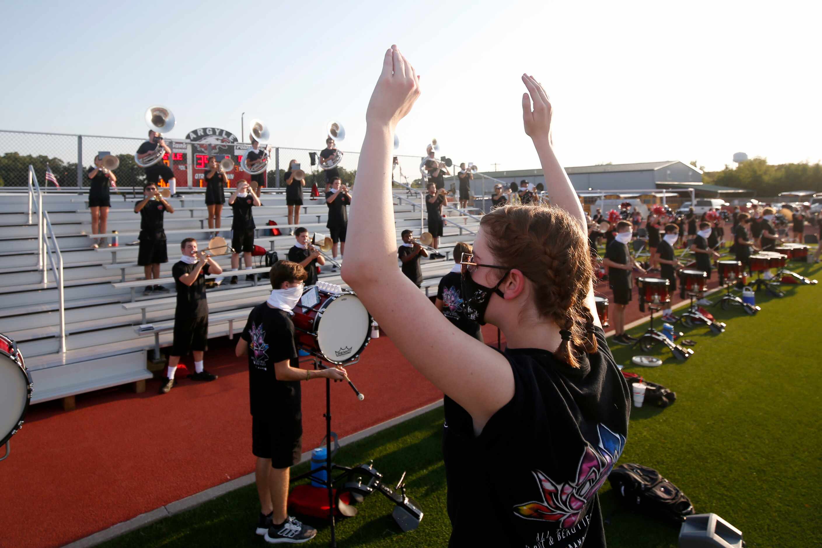 Argyle Drum major Sarah Crowder directs socially-distanced band members during a high school...