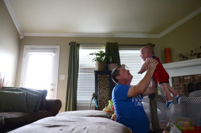 
Rockwall ISD teacher Jason Foster lifts up his son Jamison, who was born at 26 weeks, at...