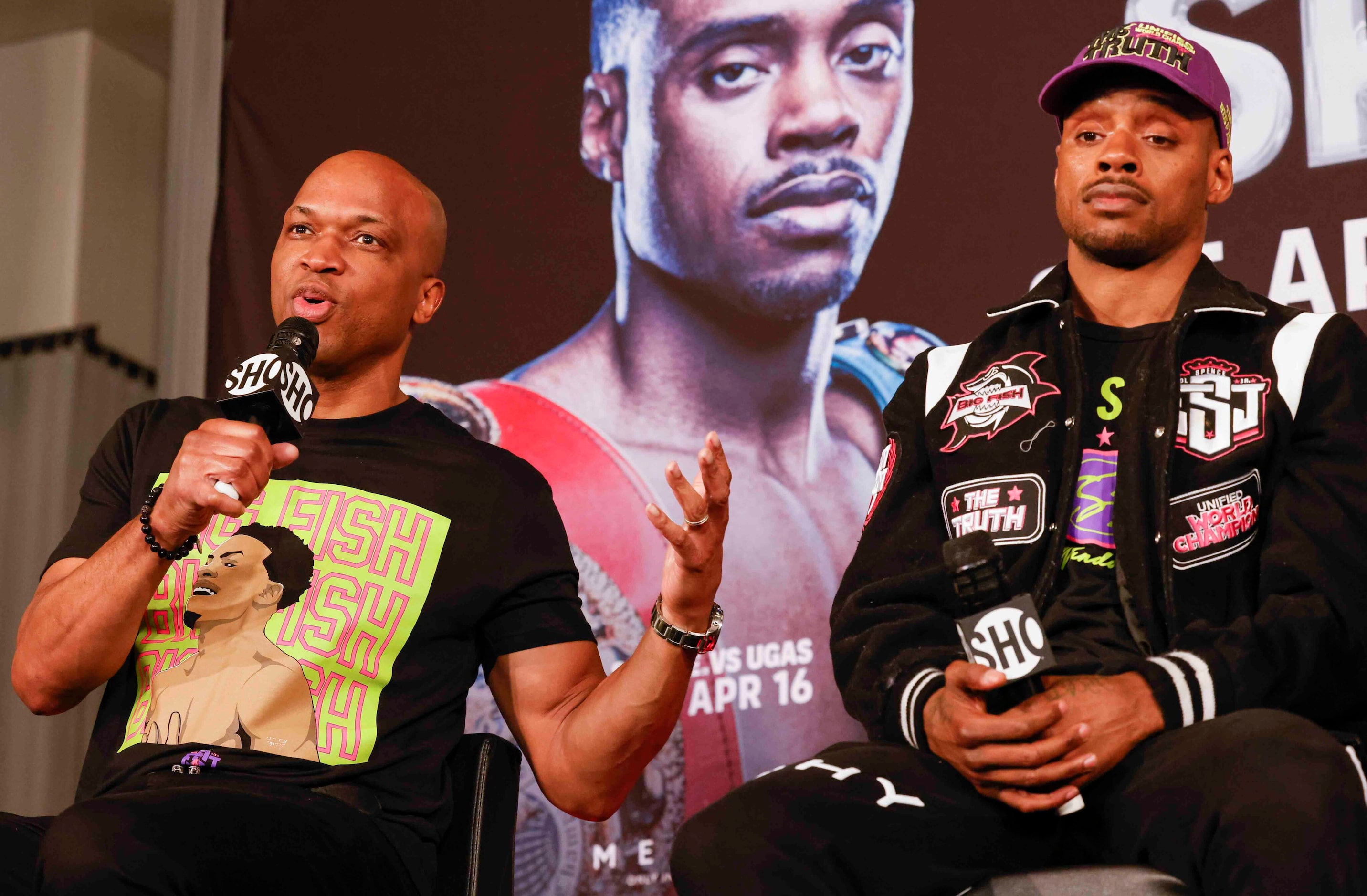 Errol Spence Jr., right, listens to his coach Derek James, as he speaks during a press...