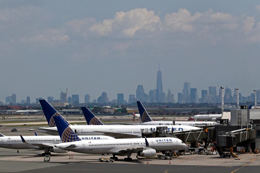 FILE In this July 22, 2014, file photo, United Airlines jets wait at gates at Newark Liberty...