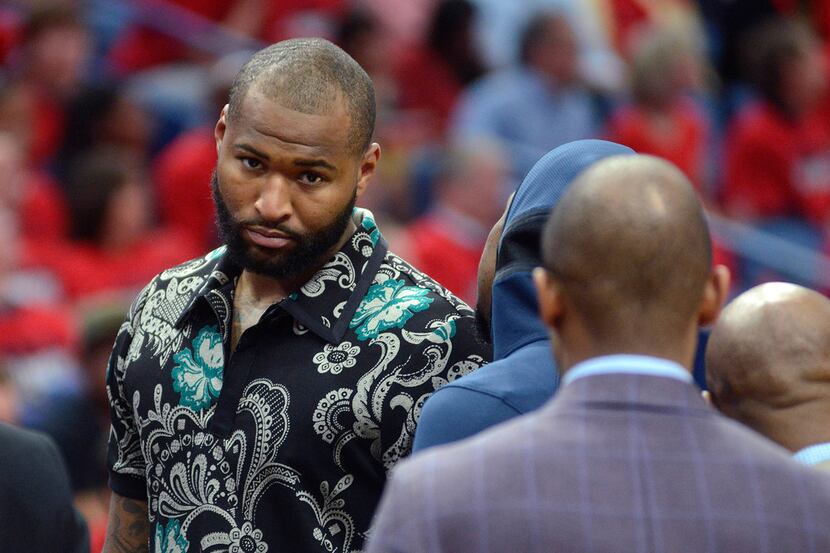 New Orleans Pelicans center DeMarcus Cousins walks on the court in street clothes during the...