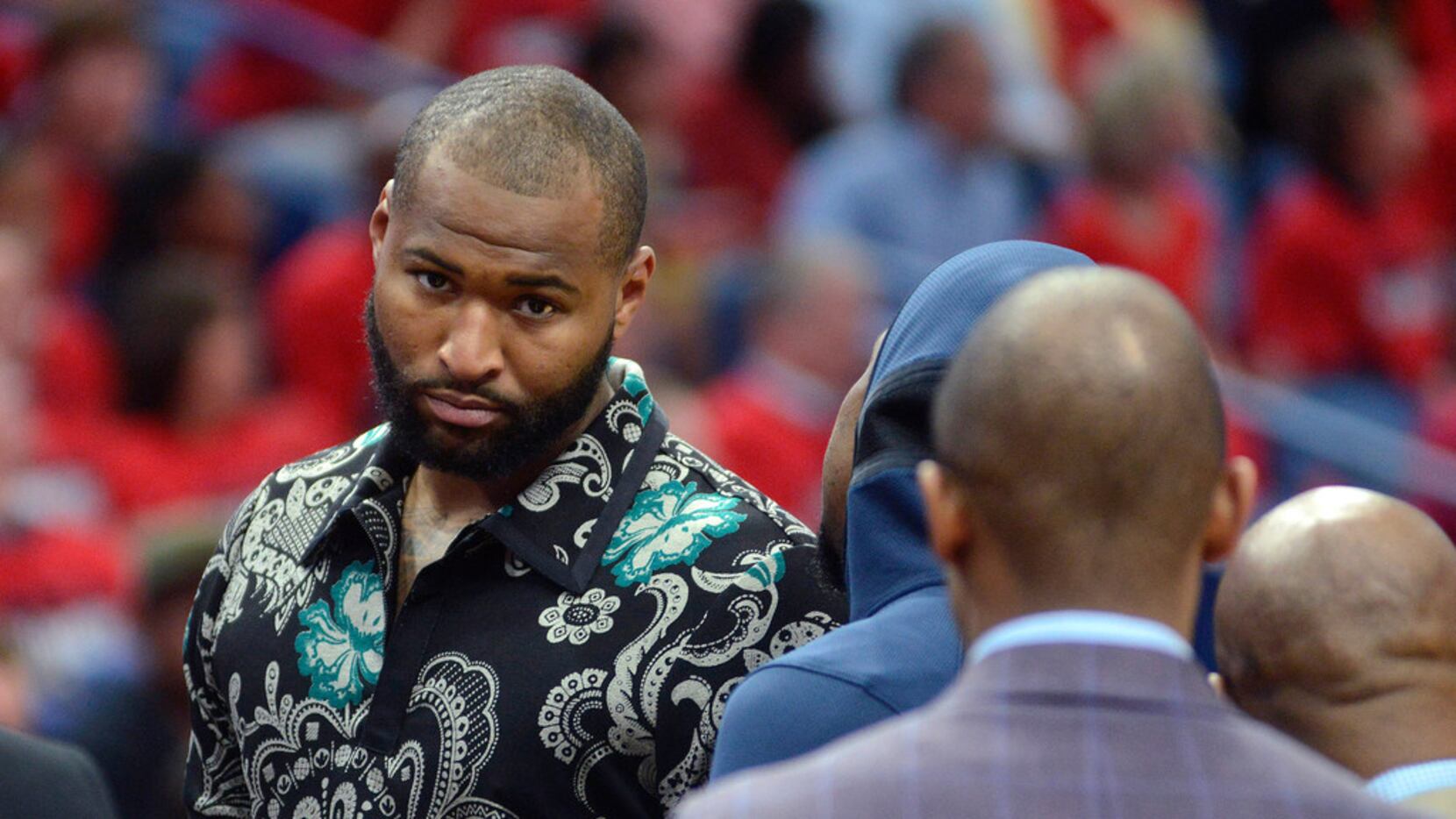 New Orleans Pelicans center DeMarcus Cousins walks on the court in street clothes during the...