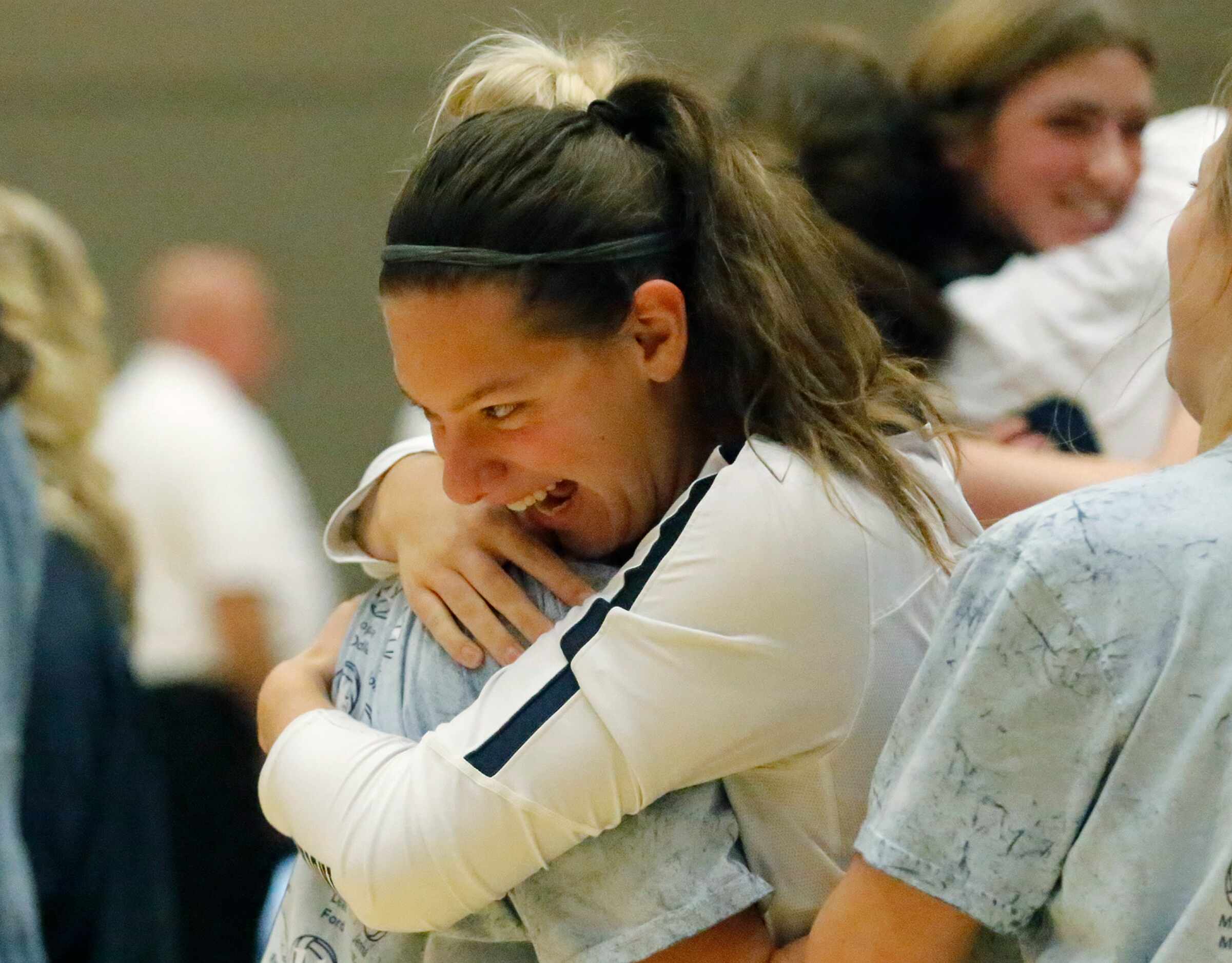 Keller High School setter Marissa Mantz (7) embraces team mates as Keller High School...