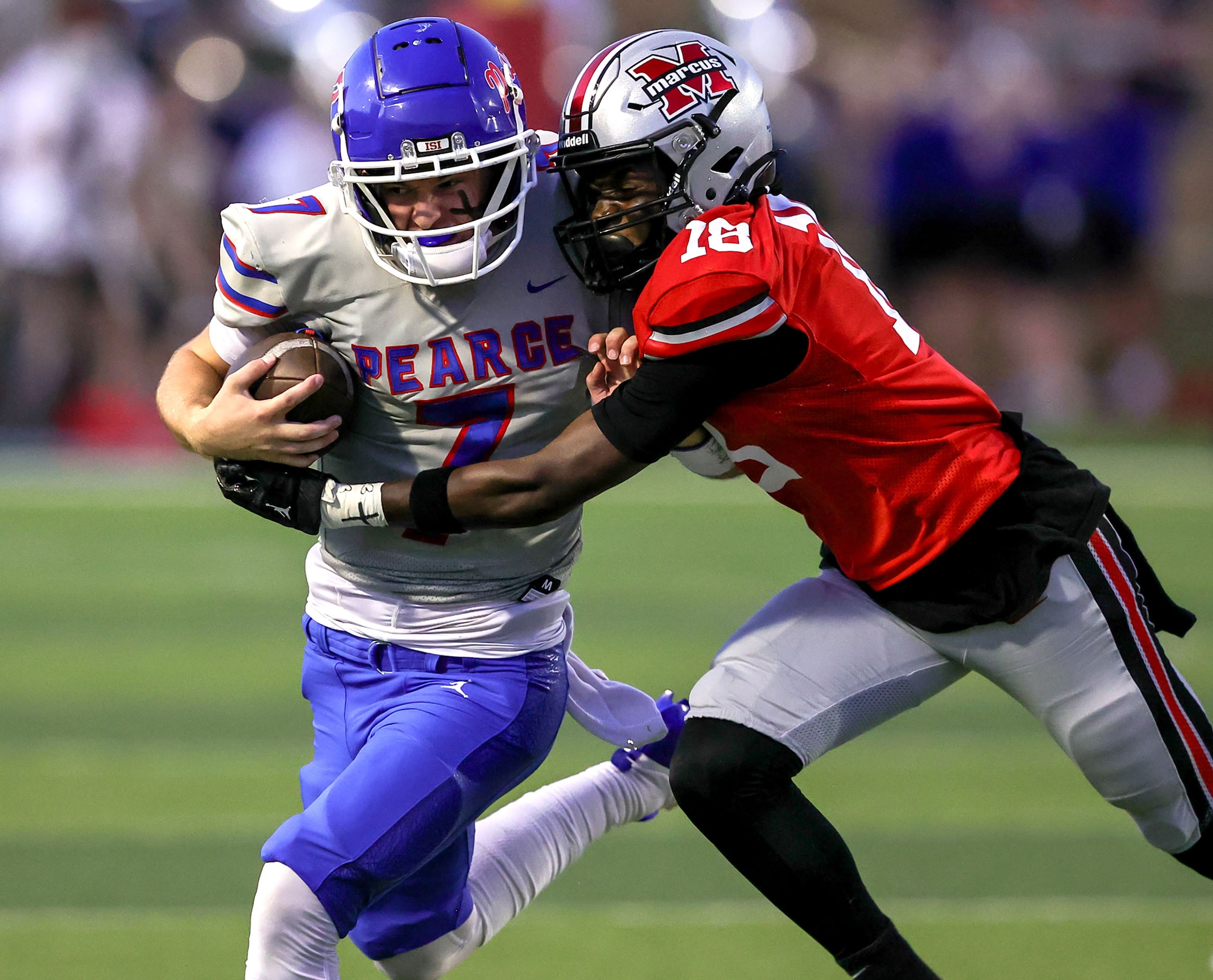 Richardson Pearce quarterback Presley Harper (7) is stopped by Flower Mound Marcus defensive...