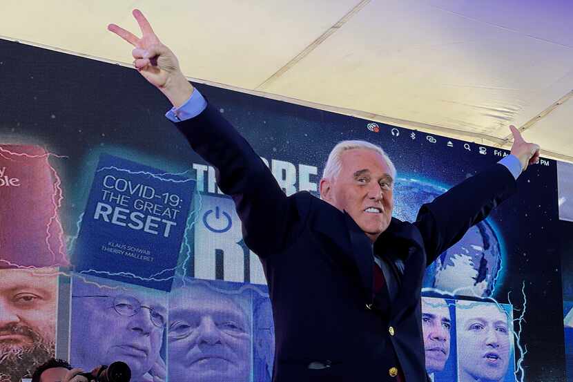 Conservative political consultant Roger Stone gestures victory to the cheering crowd during...