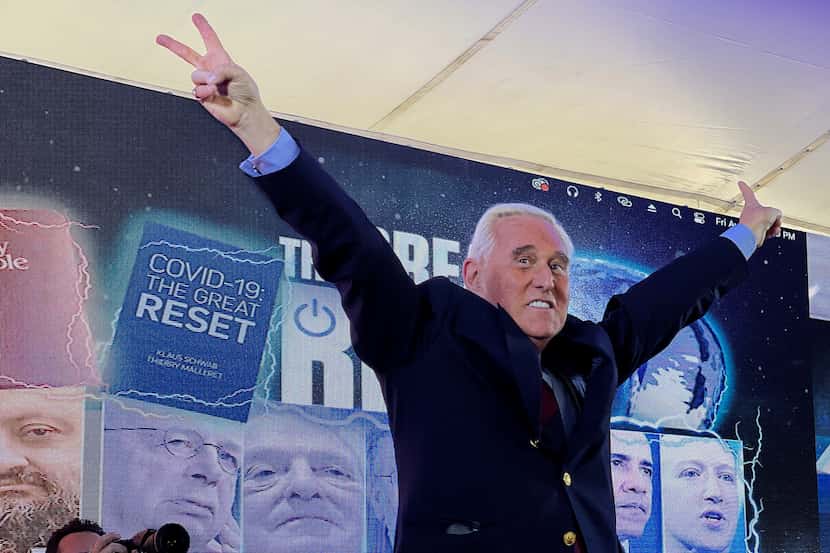 Conservative political consultant Roger Stone gestures victory to the cheering crowd during...