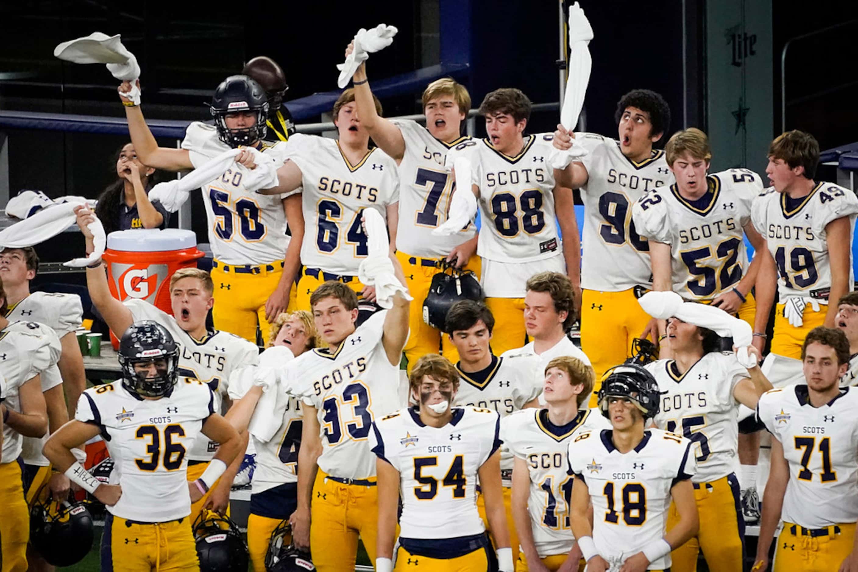 The Highland Park bench cheers on the Scots defense during the first half of a Class 5A...
