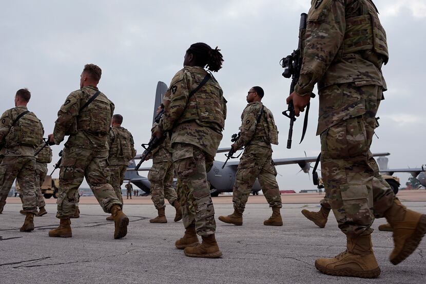 Members of the Texas National Guard prepare to deploy to the Texas-Mexico border in Austin...