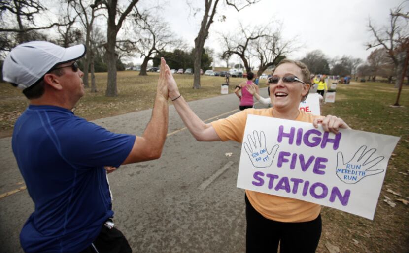 Shalane Durbin of Dallas gives out high fives at the "high five station," in the White Rock...