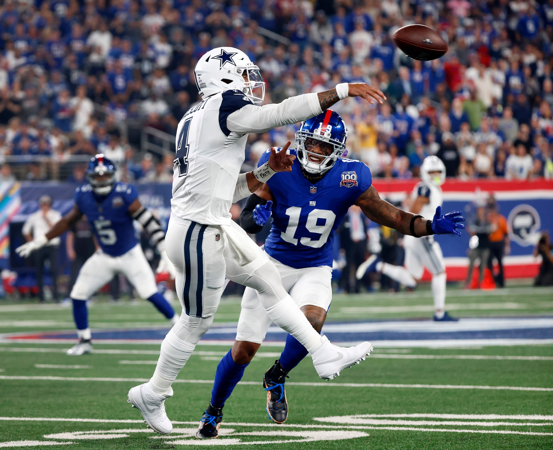 Dallas Cowboys quarterback Dak Prescott (4) throws on the run against New York Giants...