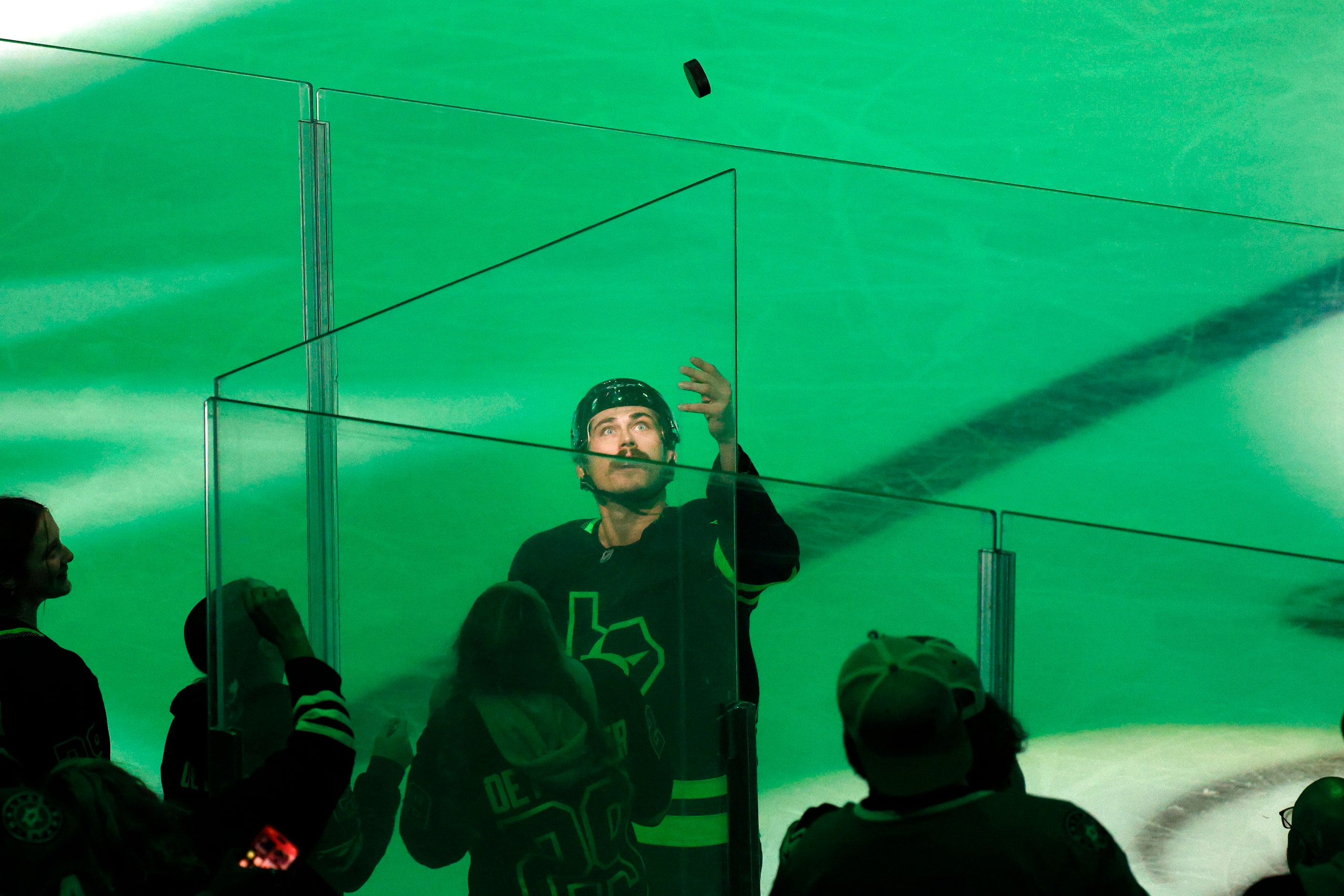 Dallas Stars left wing Mason Marchment (27) tosses a puck for fans after their 5-3 victory...