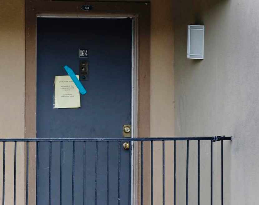 
A sign on the door of the apartment where Thomas Eric Duncan stayed warns that the unit is...