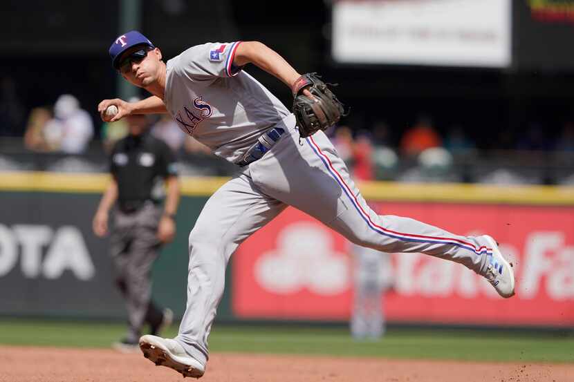 Texas Rangers shortstop Corey Seager fields a ground out hit by Seattle Mariners' Carlos...