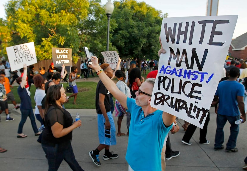 
Todd Whitley showed his support for the protesters, most of them black, who marched outside...