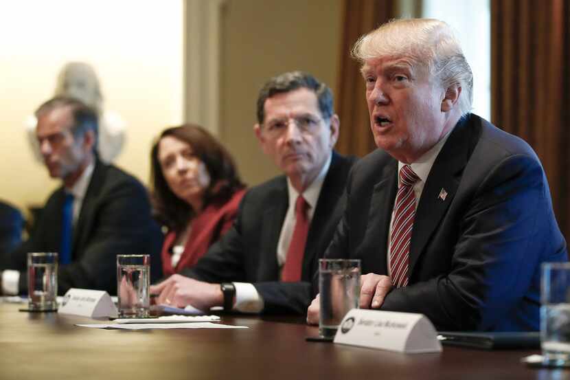 President Donald Trump, joined by, from left, Sen. John Thune, R-S.D., Sen. Maria Cantwell,...