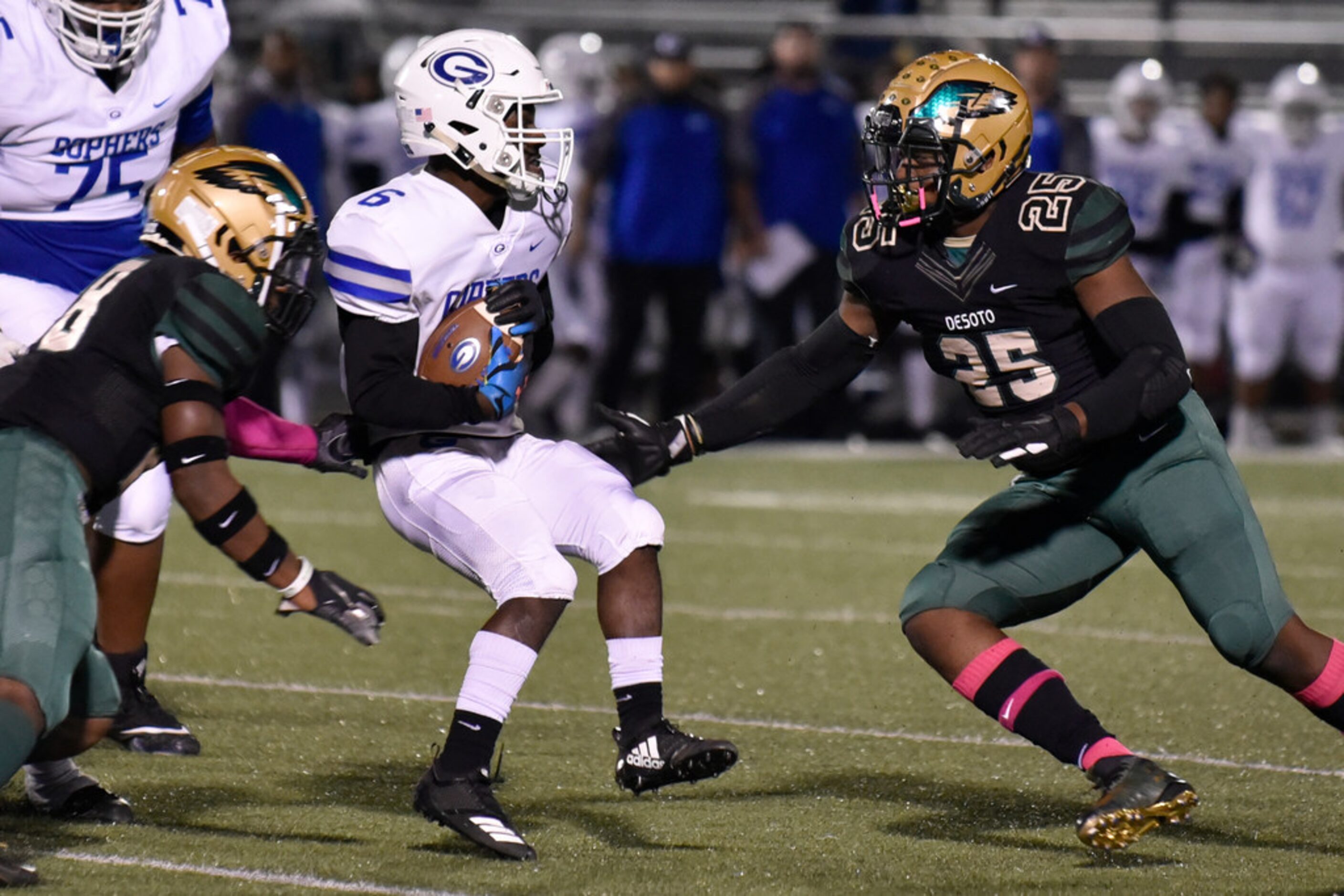 Grand Prairie High School senior running back Tylexius Straughter (6) spins through tackles...