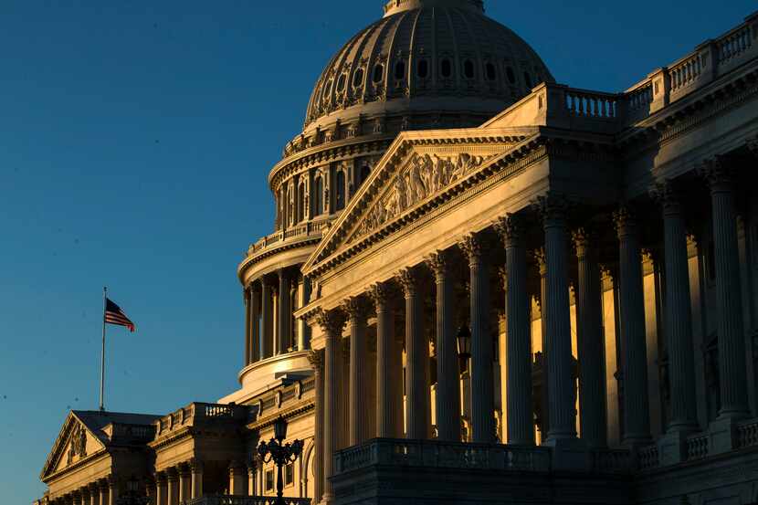 The U.S. Capitol building is illuminated by the rising sun, Wednesday, Dec. 18, 2019, on...