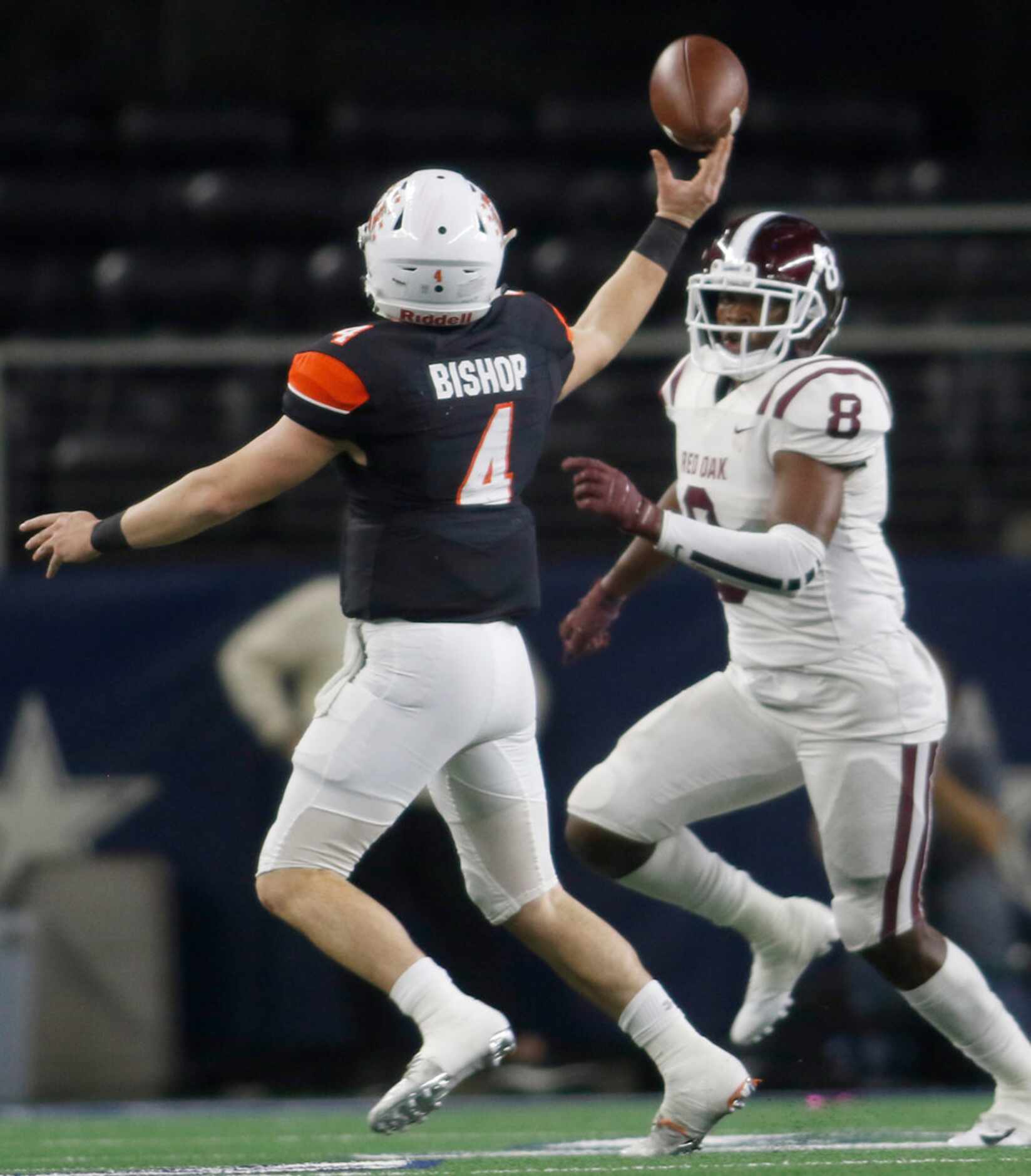 Aledo quarterback Jake Bishop (4) launches a pass toward the end zone over the defense of...