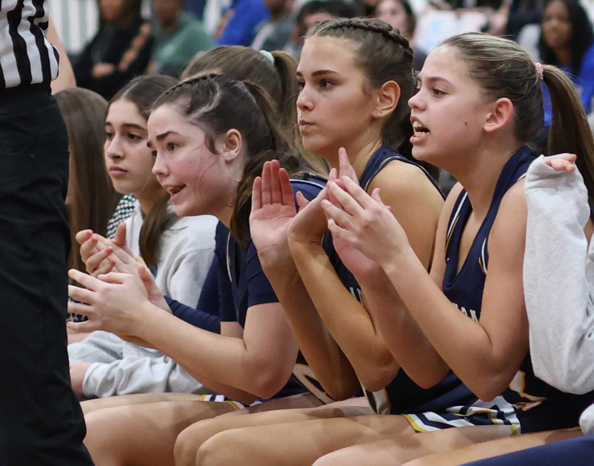 Highland Park players voice their support from the team bench area during first half action...