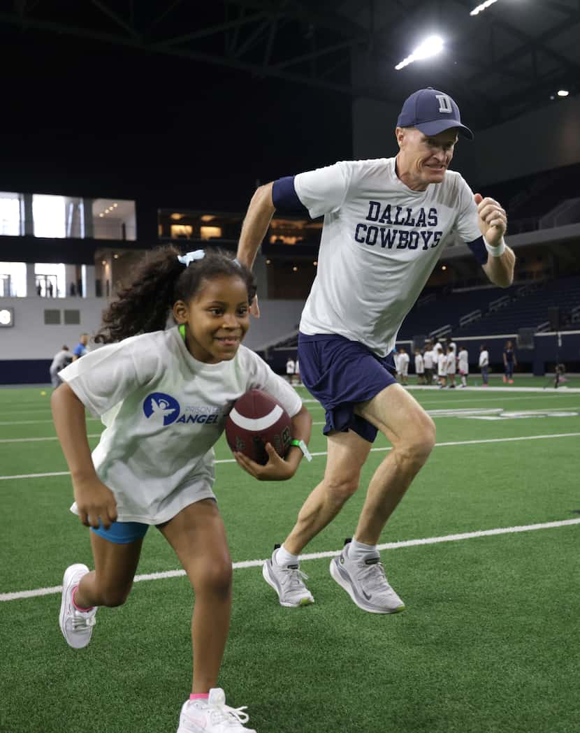 6-year-old Aaliyah Henderson, left, races coach John Fassel during a Prison Fellowship Angel...