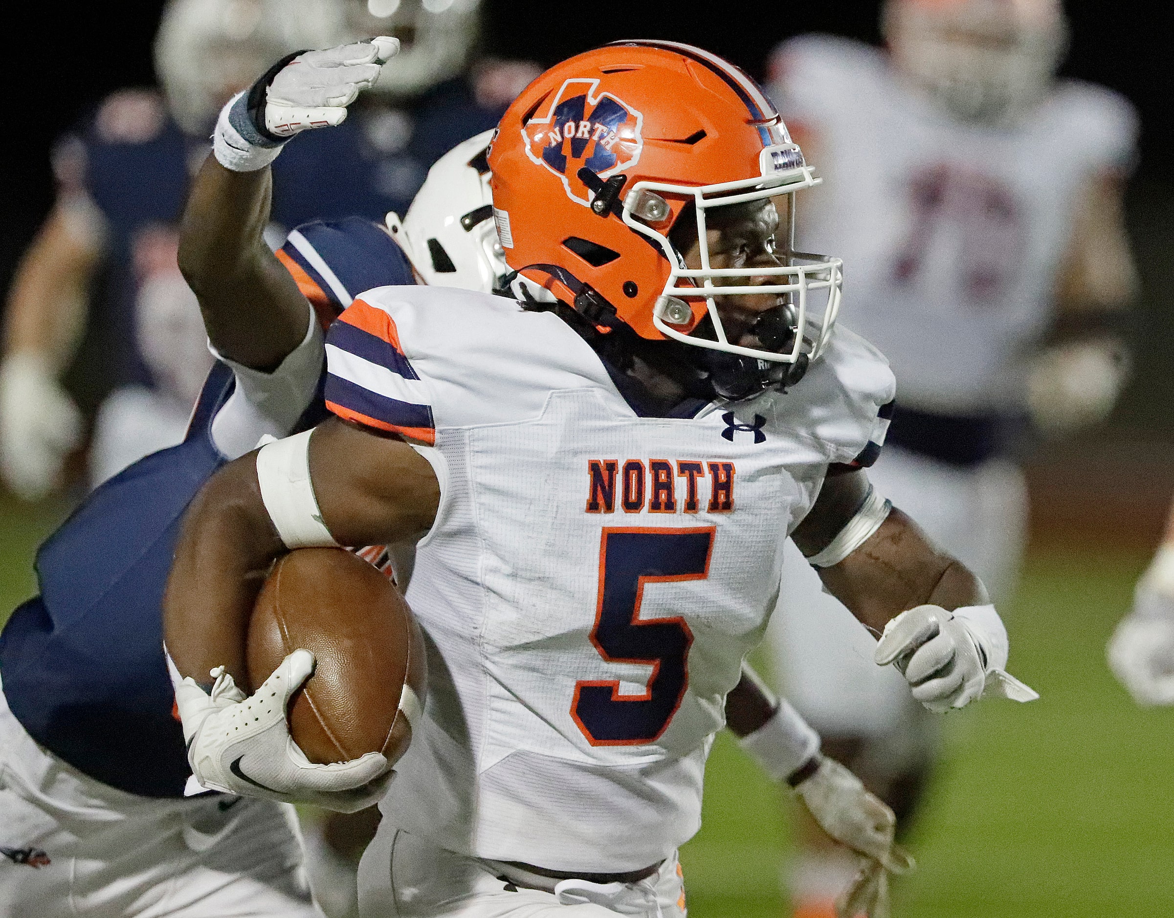 McKinney North High School running back Greg Ard (5) outruns Wakeland High School safety...