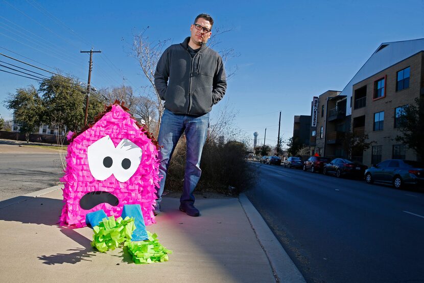 Artist Giovanni Valderas beside one of his pieces in Dallas 