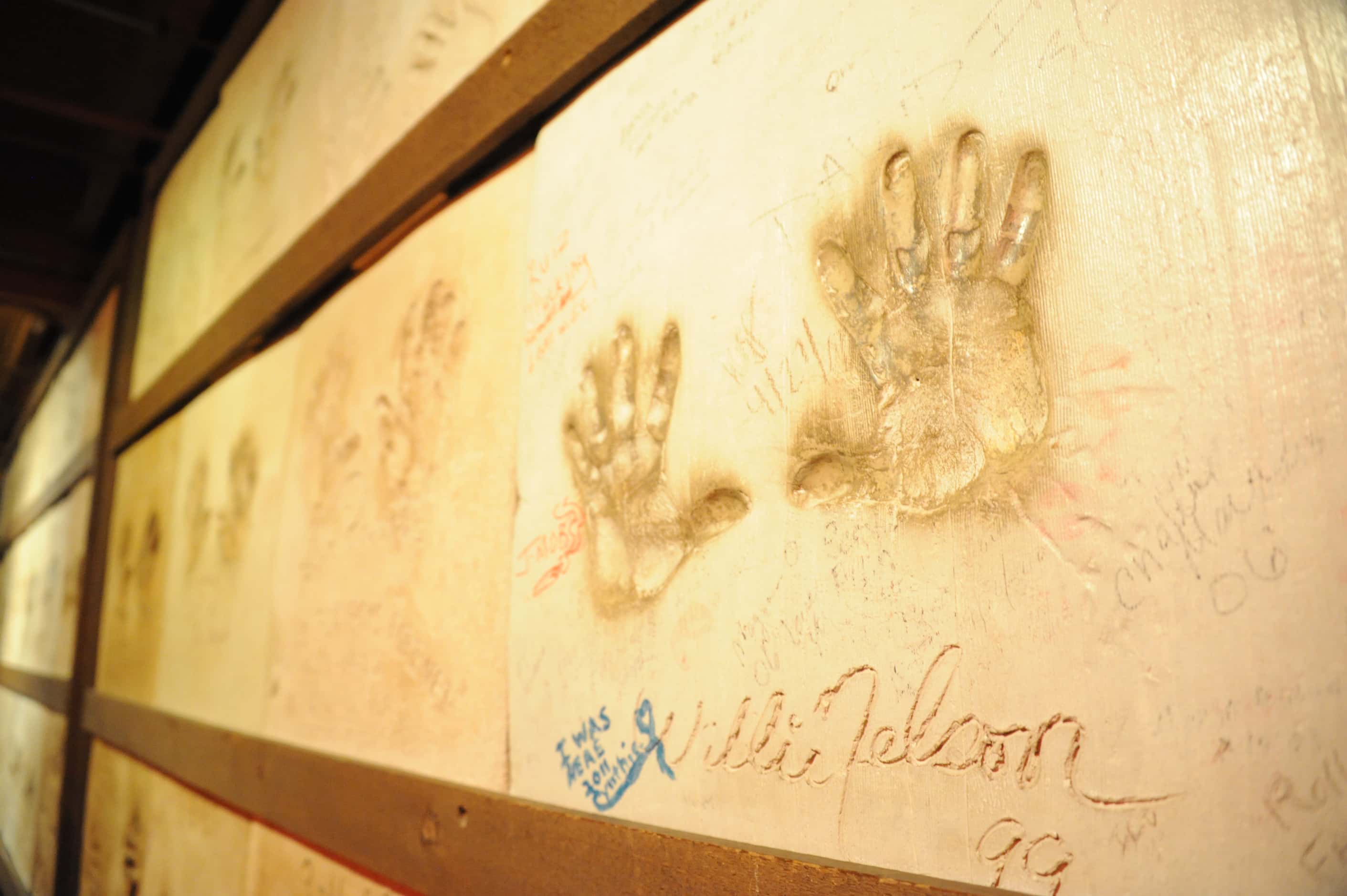 2012 - Handprints by celebrity artists, such as Willie Nelson (right), are pressed in cement...