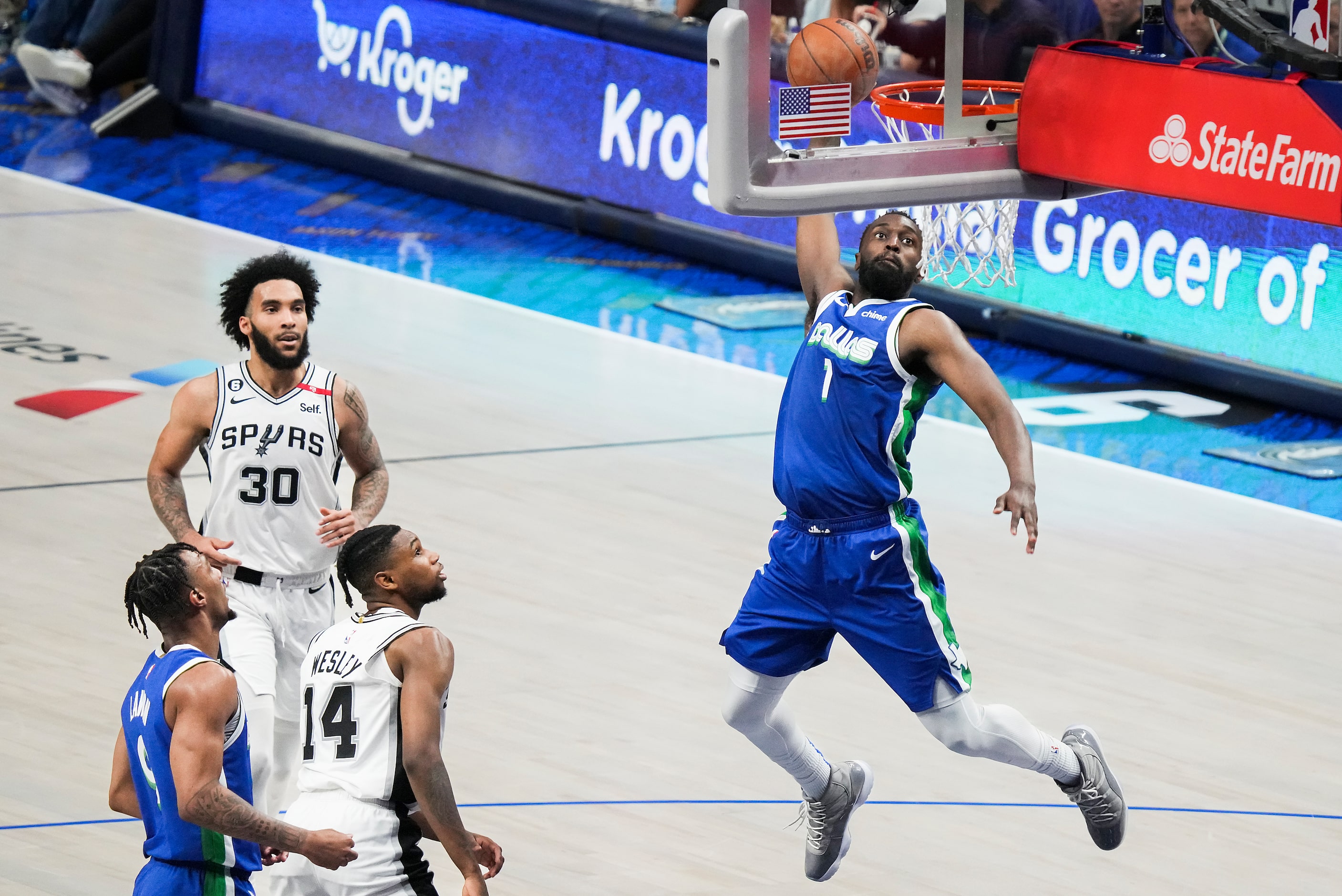 Dallas Mavericks guard Theo Pinson (1) dunks the ball past San Antonio Spurs guard Blake...