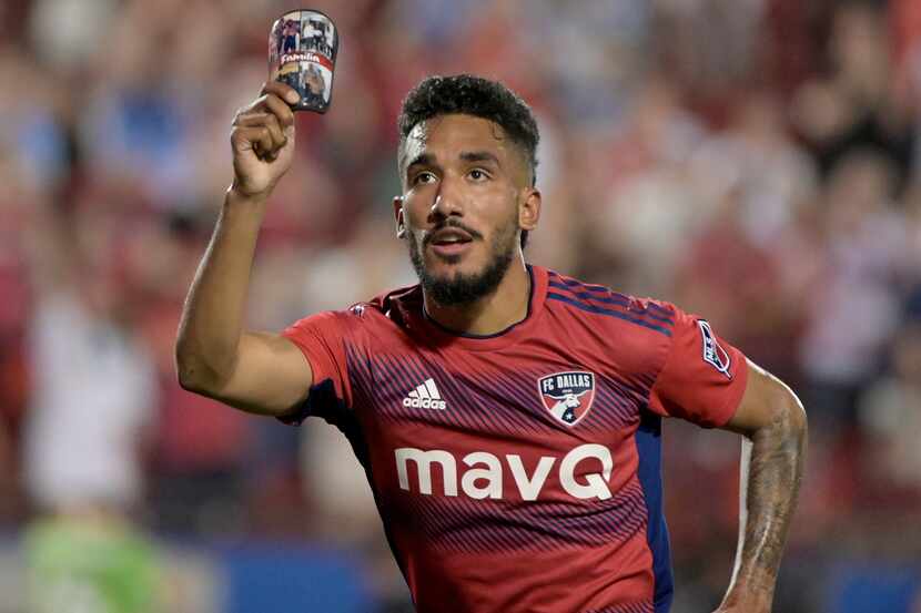 FC Dallas forward Jesús Ferreira (10) celebrates a goal while holding a picture of his...