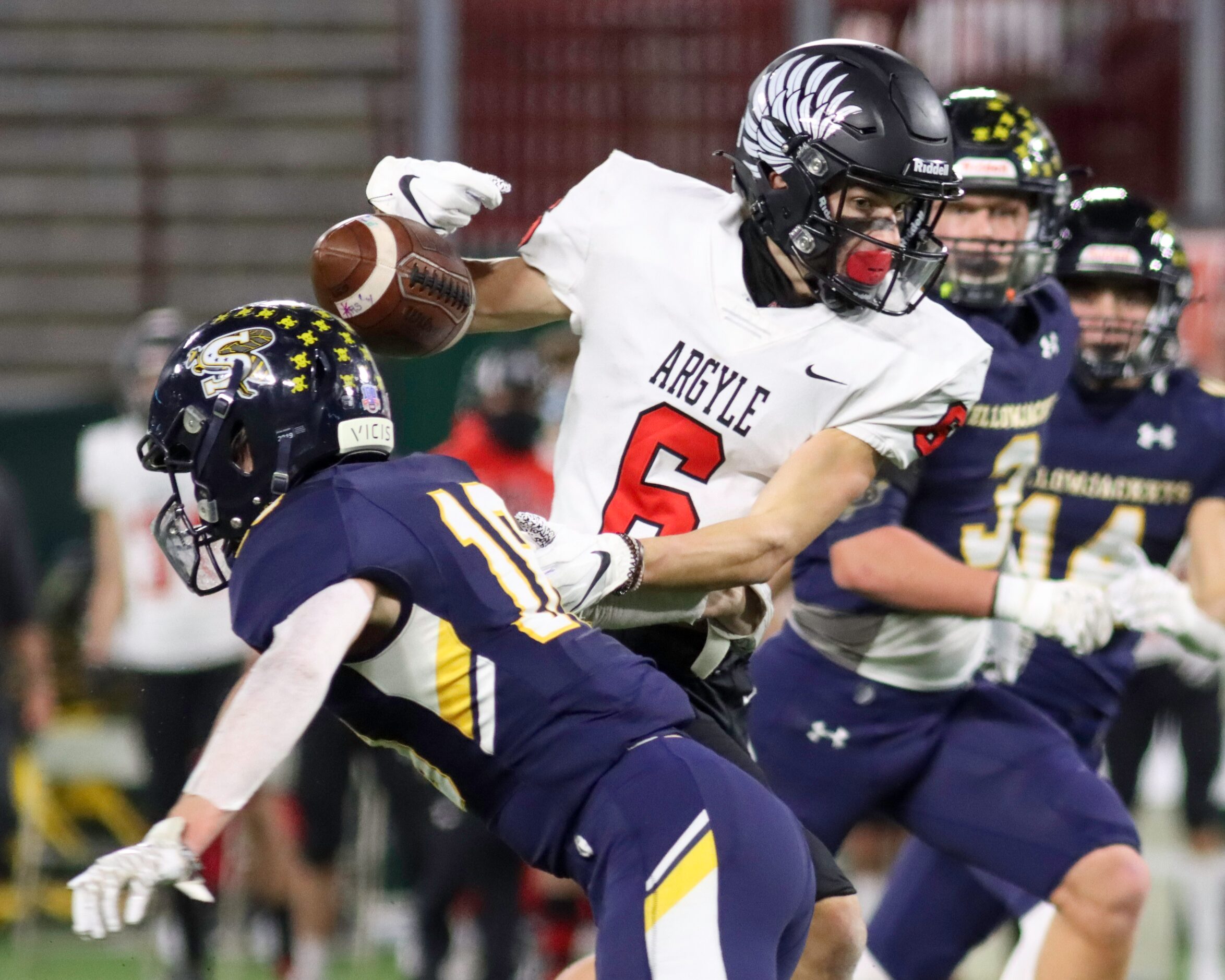 Stephenville defensive back Payton Poston (18) forces a fumble from Argyle wide receiver...