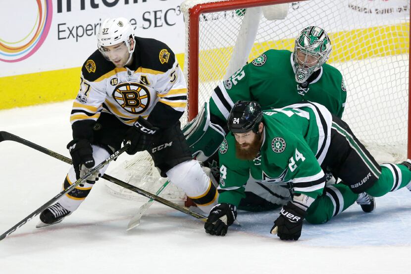Boston Bruins center Patrice Bergeron (37) gets the puck into the net scoring a goal against...