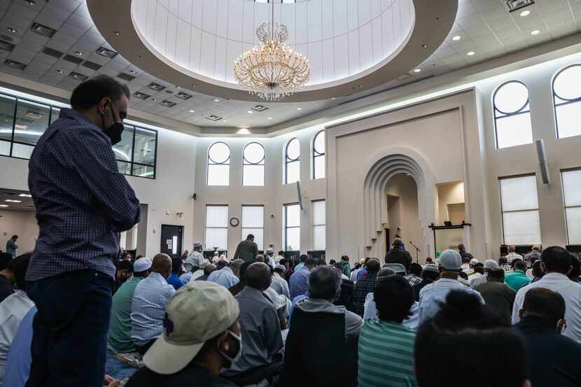 A group of Muslim men gather at the mosque main prayer hall to celebrate Friday afternoon...