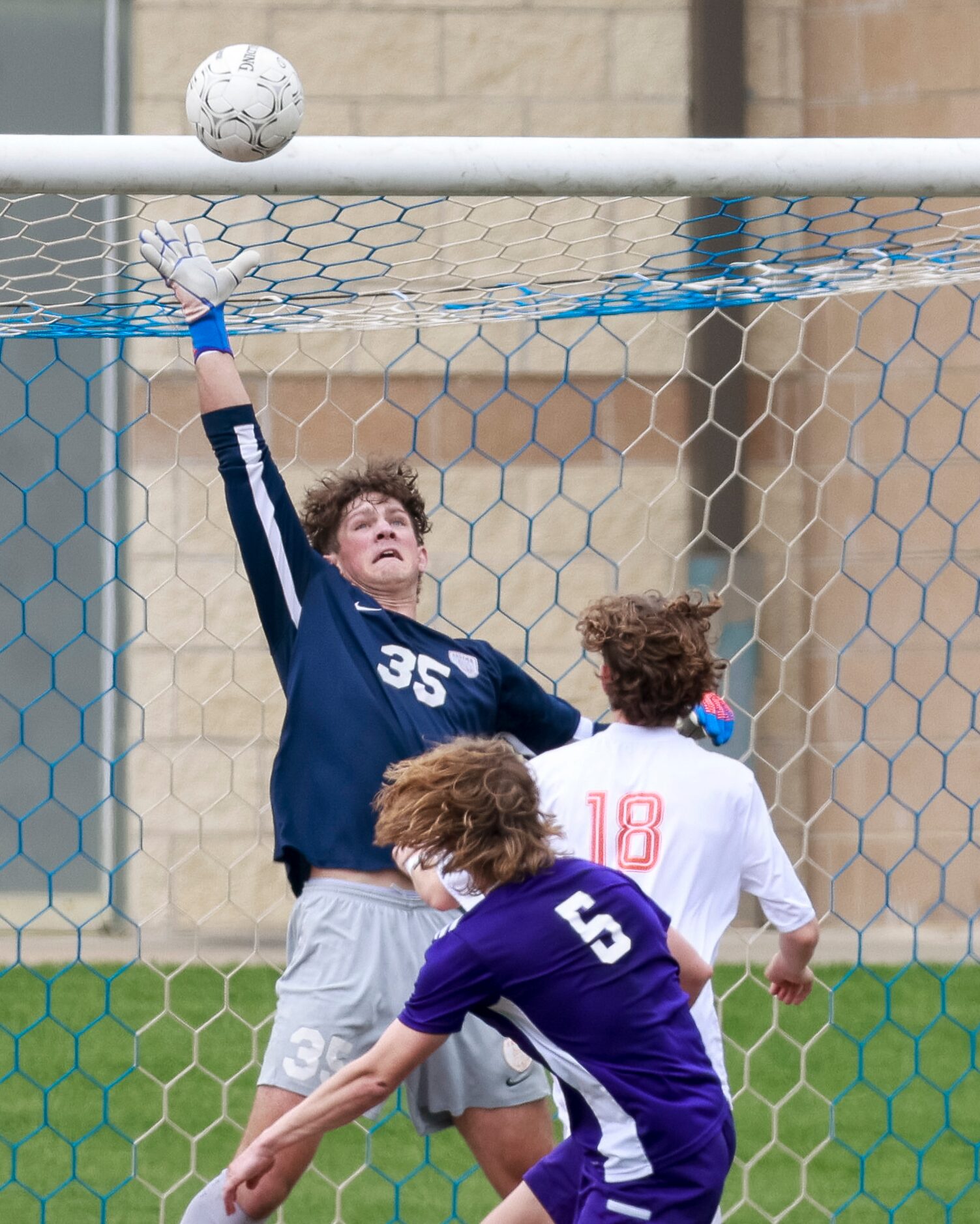 Celina goalkeeper Nathan Yost (35) jumps to knock the ball away alongside Celina midfielder...