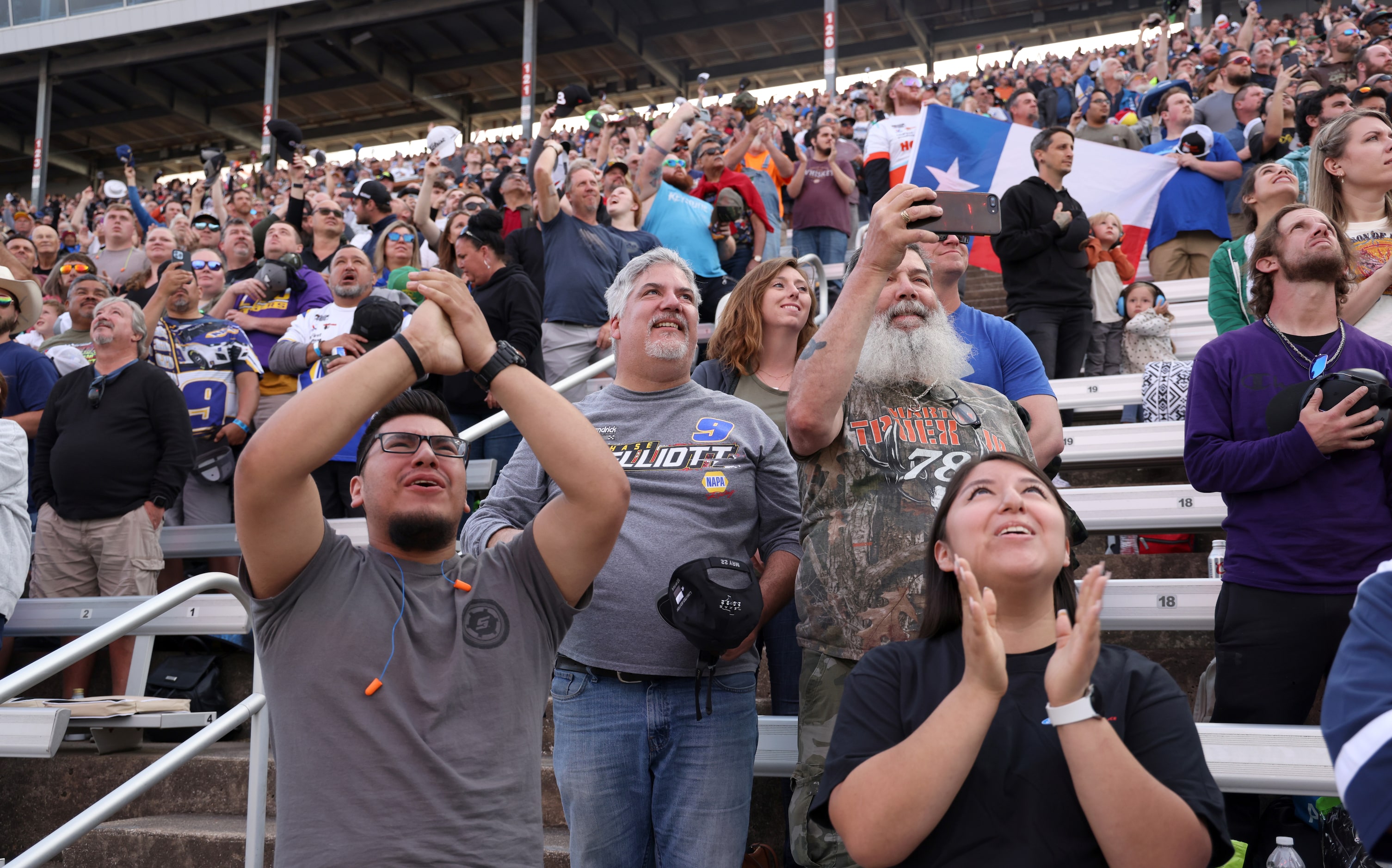 Carlos, left, and Graciela Perez of Dallas (front row) are surrounded by a large crowd of...