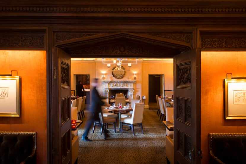 A waiter walks through the dining area at The Mansion Restaurant, designed by Phillip...