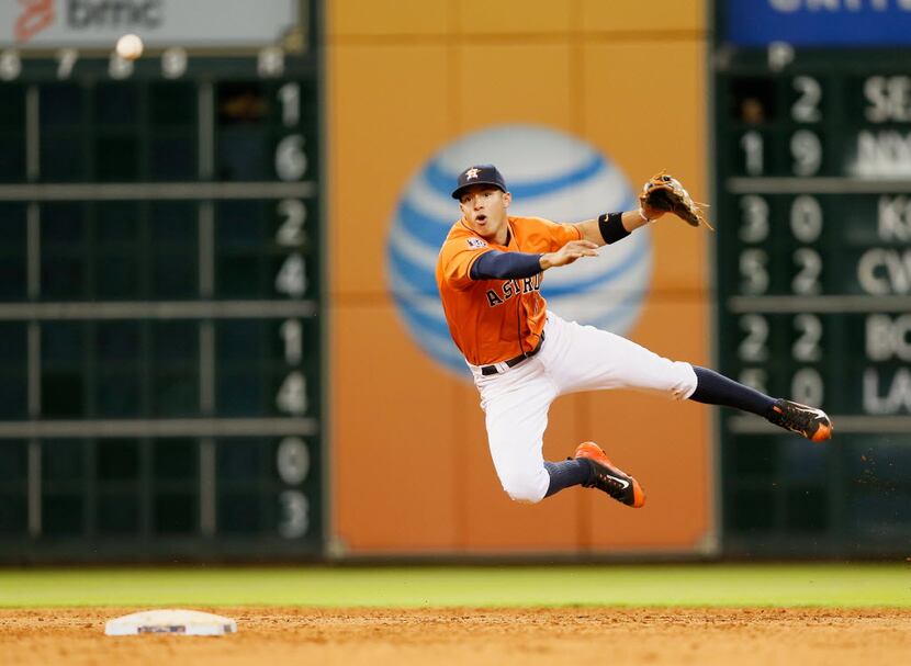 HOUSTON, TX - JULY 17:  Carlos Correa #1 of the Houston Astros makes a diving throw to...