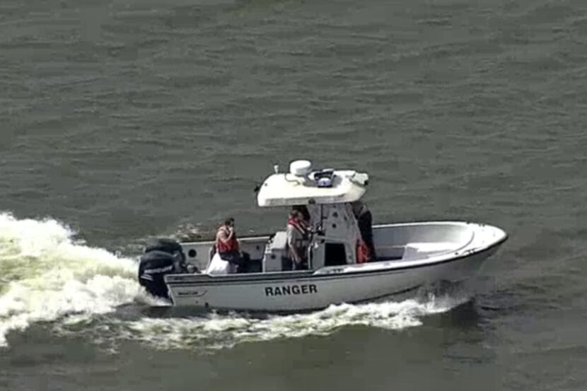 Responders trolled Lewisville Lake after a man jumped from the Interstate 35E bridge into...