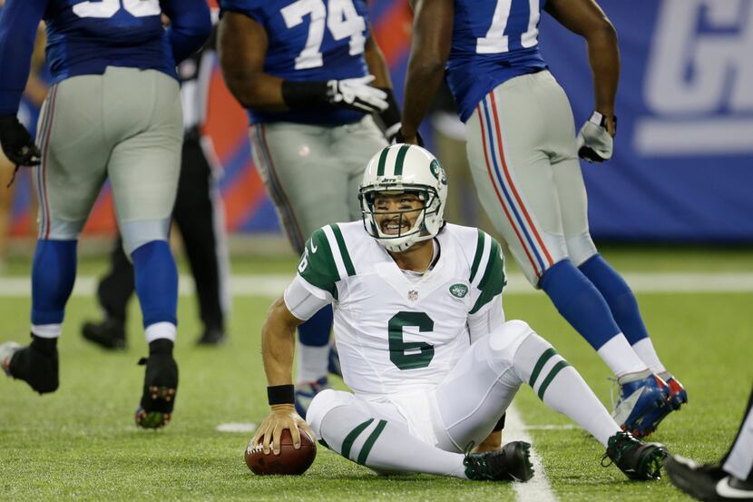New York Jets quarterback Mark Sanchez (6) smiles after being sacked by New York Giants...