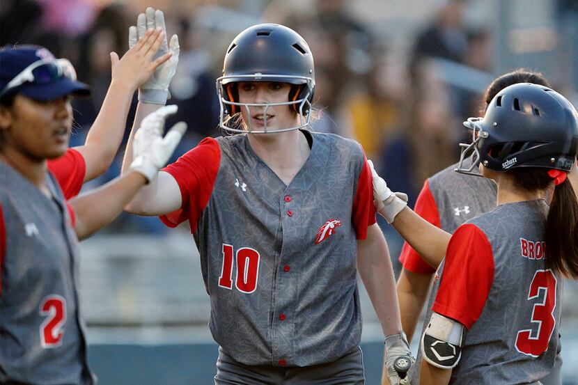 McKinney Boyd High School pitcher Kinsey Kackley (10) is greeted by team mates after...