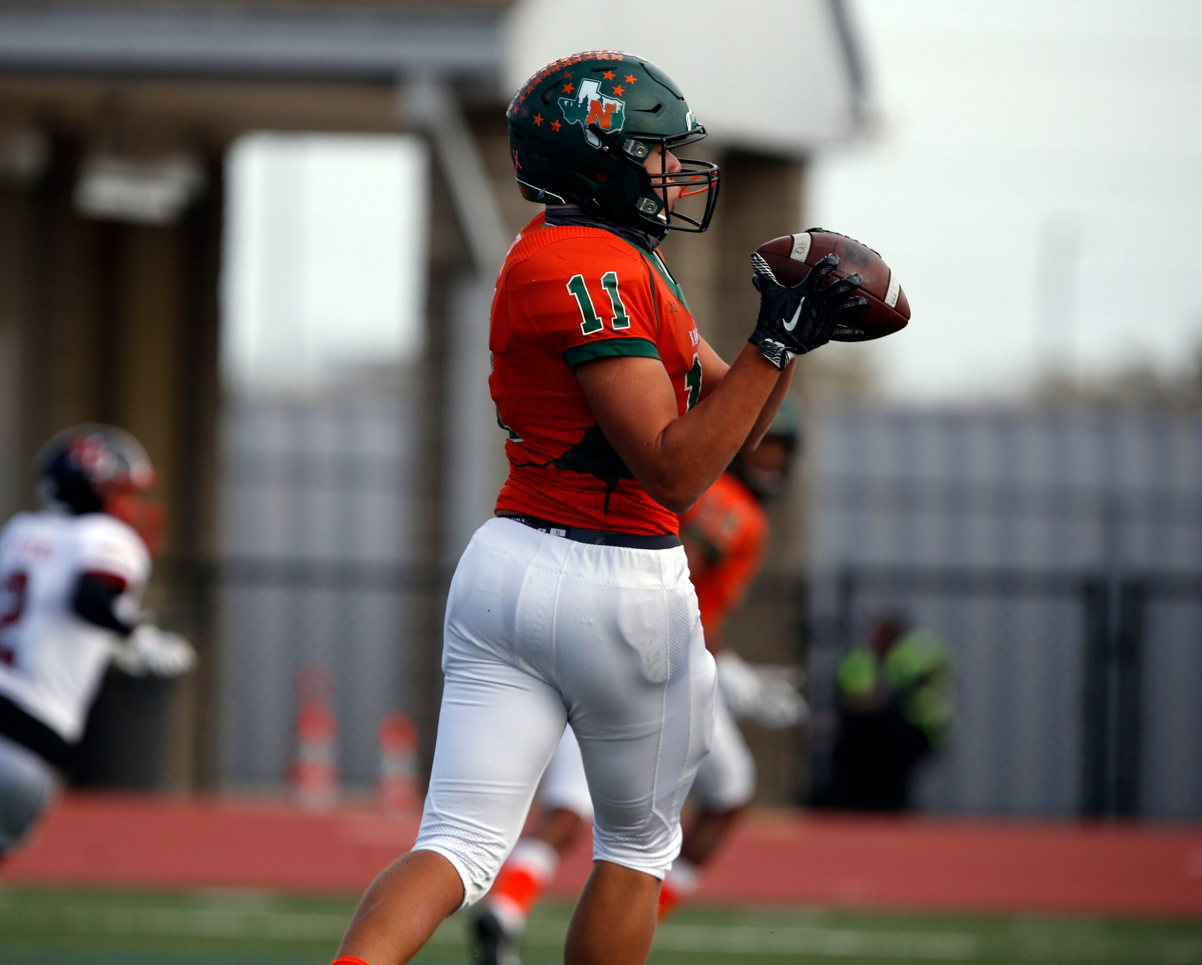 Naaman Forest’s Devean Deal (11) fields a touchdown pass during the first quarter of a high...