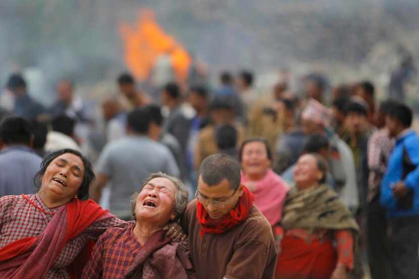 
Family members were overcome during the cremation of earthquake victims in Bhaktapur, near...